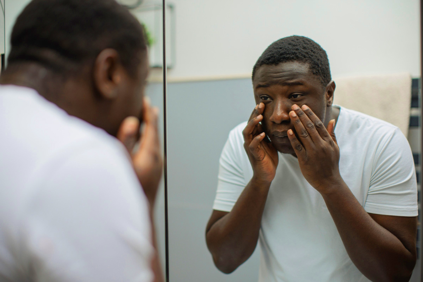 Man touching his face