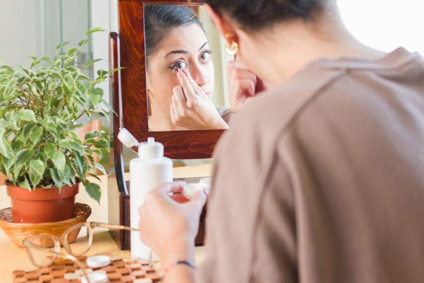 Woman putting contacts in eye
