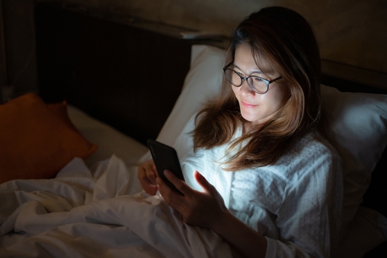 Person using the phone right before bedtime