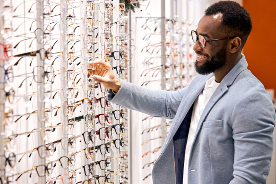 Man browsing glasses at eye doctor